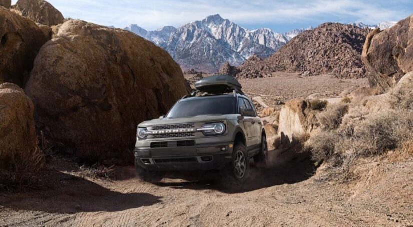 A grey 2023 Ford Bronco Sport is shown on a trail kicking up dust after winning a 2023 Ford Bronco Sport vs 2023 Kia Seltos showdown.