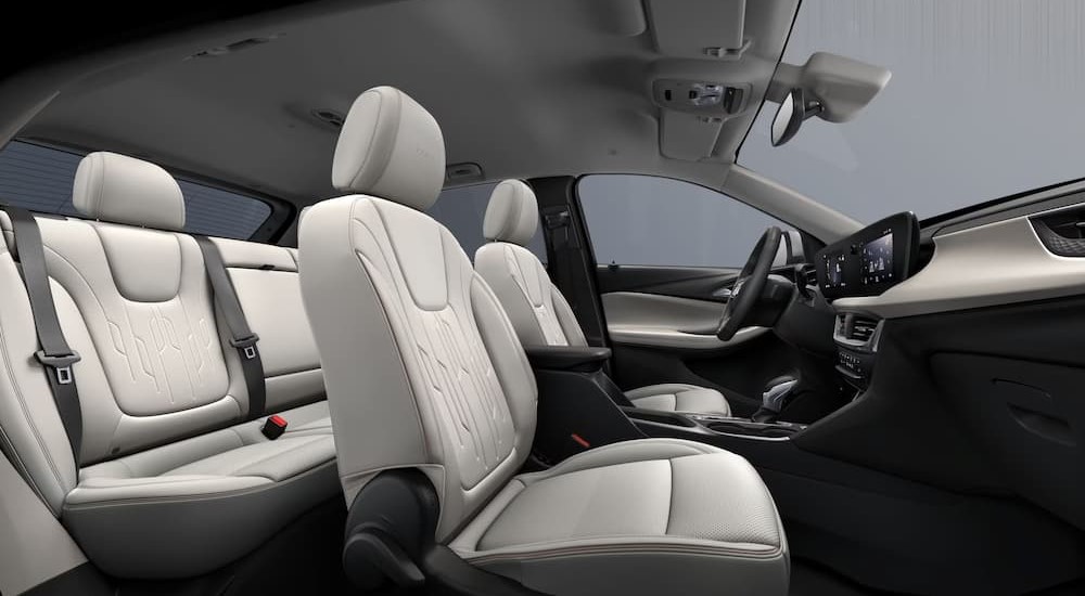 The black and white interior and dash of a 2024 Buick Encore GX is shown.