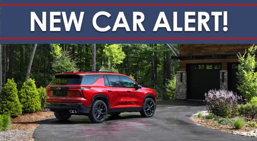 A red 2024 Chevy Traverse RS is shown from the rear at an angle under a new car alert banner.