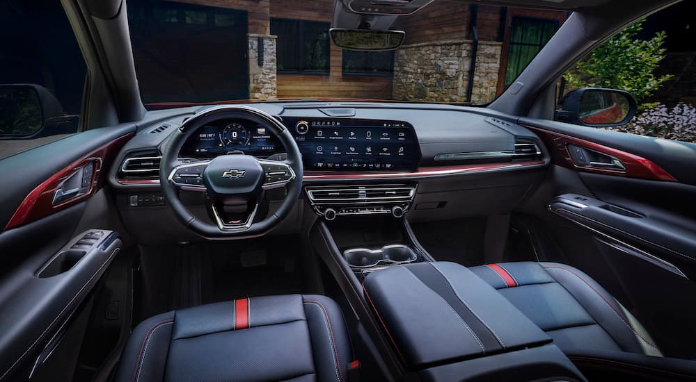 The black interior of the 2024 Chevy Traverse RS is shown from the driver's seat.