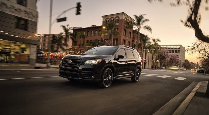 A black 2022 Subaru Ascent is shown from the front at an angle after leaving a dealer that has Subarus for sale.