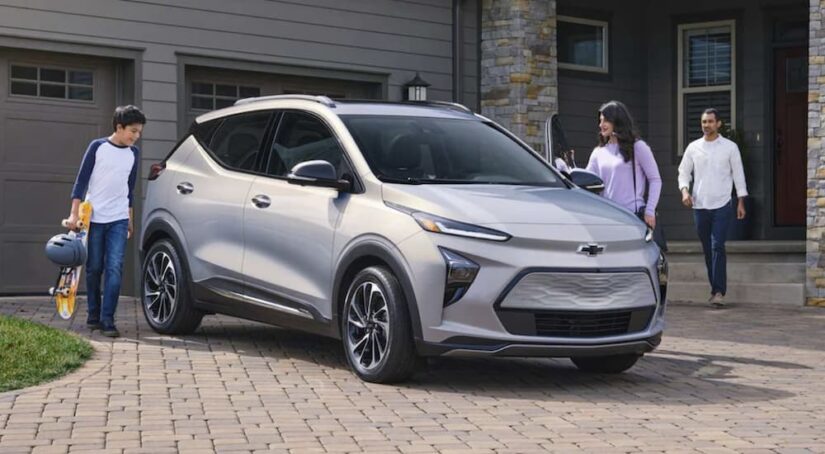 A silver 2023 Chevy Bolt EUV is show parked on a driveway after visiting a Chevy dealer.