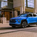 A blue Chevy Trailblazer RS is shown parked near a building.