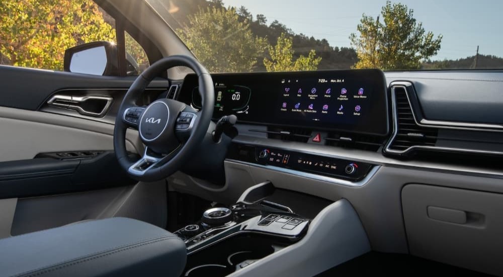 The gray and black interior and dash of a 2023 Kia Sportage Hybrid is shown.
