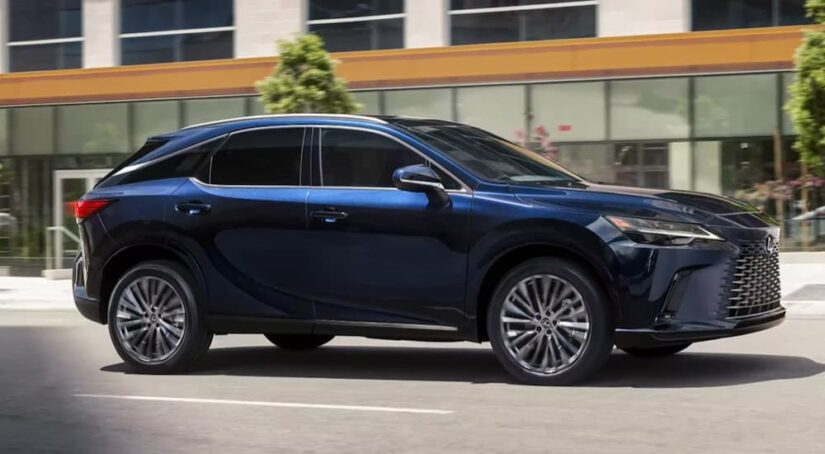 After getting a Lexus RX 350 lease, a blue 2023 Lexus RX 350, is shown driving on a city street.