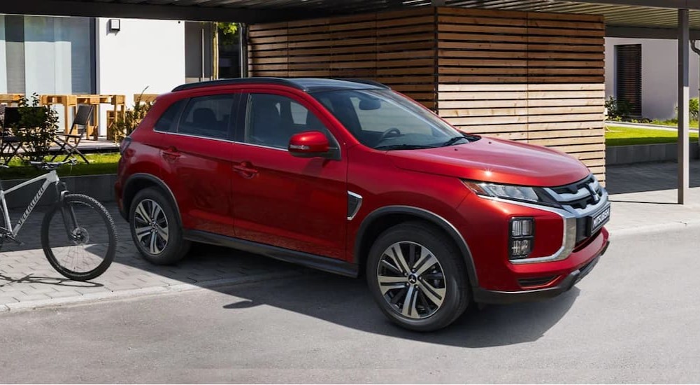 A red 2023 Mitsubishi RVR is shown parked on a driveway.