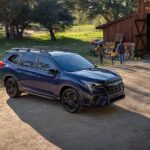 A blue 2023 Subaru Ascent for sale is shown parked near a barn.