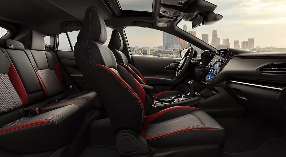 The black and red interior and dash of a 2024 Subaru Impreza is shown.
