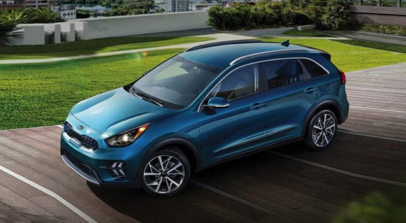 A blue 2021 Kia Niro is shown from a high angle after leaving a used Kia dealer.