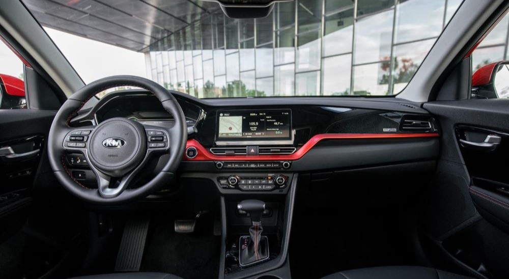 The black dash with red accents is shown in a 2021 Kia Niro.