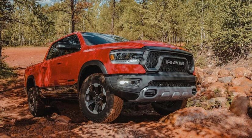 A red 2023 Ram 1500 Rebel is shown from the front at an angle after leaving a Winchester Ram dealer.