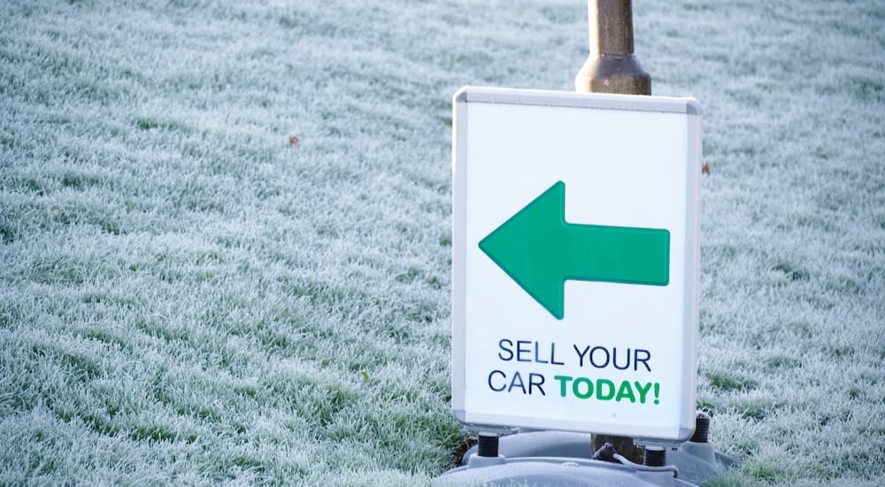 A sell your car today sign is shown.