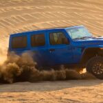 A blue 2021 Jeep Wrangler Rubicon 392 is shown from the side while off-road.