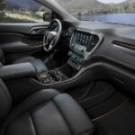 The black interior and dash of a 2023 GMC Arcadia for sale is shown