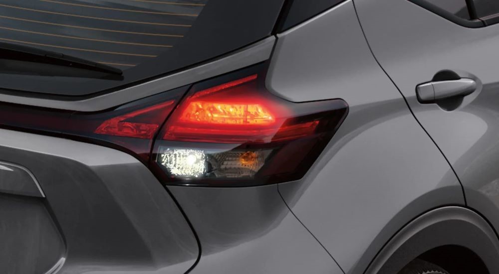 A close up shows the passenger side taillight on a grey 2023 Nissan Kicks.