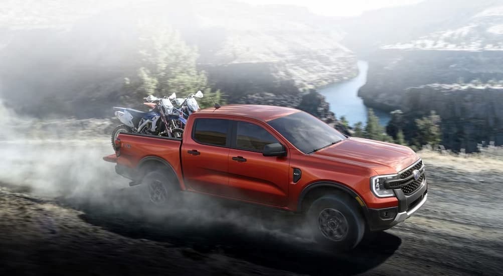 A red 2024 Ford Ranger is shown driving off-road.