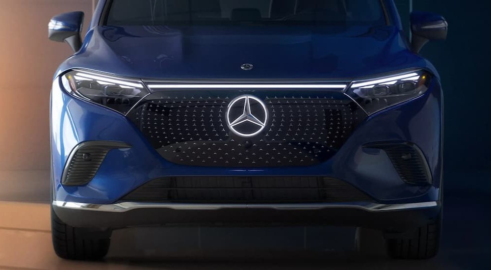 A blue 2024 Mercedes-Maybach EQS 680 SUV is shown parked from a front angle.