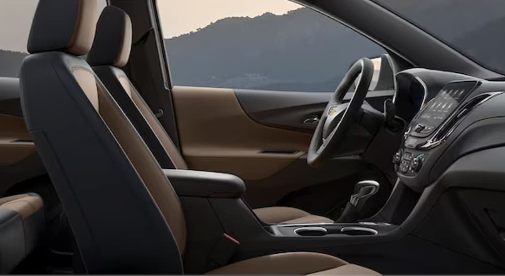 The tan and black interior and dash of a 2024 Chevy Equinox is shown.