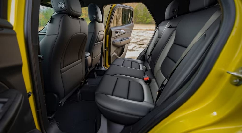 The black and gray rear interior of a yellow 2024 Chevy Trailblazer is shown.
