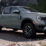 A gray 2024 Ford Ranger is shown parked on a beach.