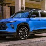 A blue 2024 Chevy Trailblazer RS is shown parked near a building.