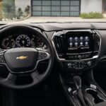 The black interior and dash of a 2022 Chevy Traverse is shown.