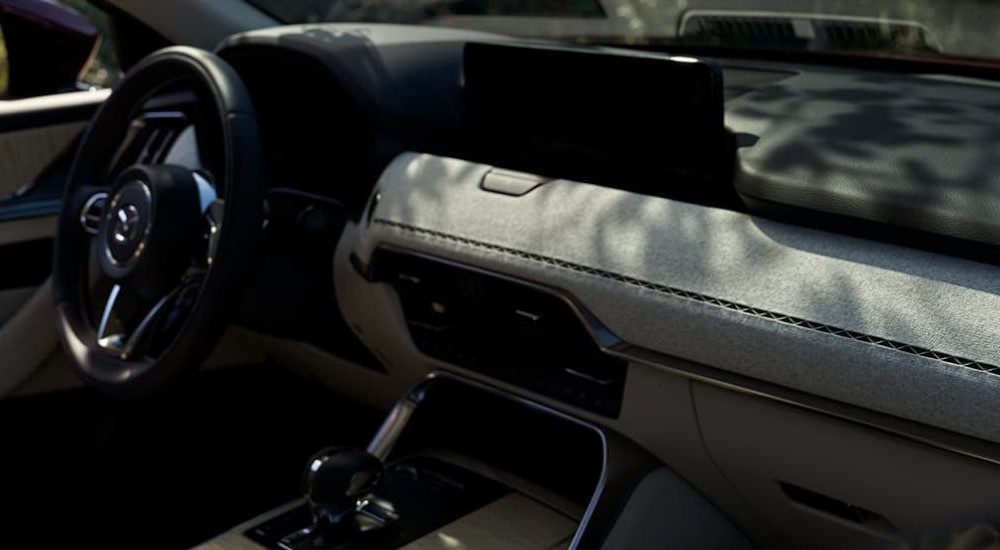 A close up shows the grey dash in a 2024 Mazda CX-90.