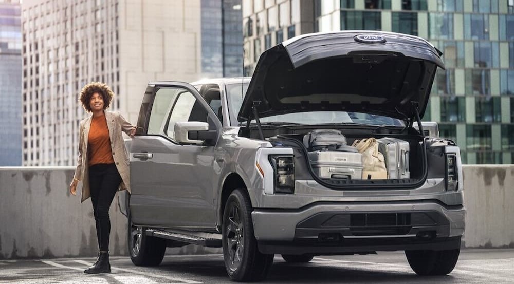 The cargo area of a silver 2023 Ford F-150 Lightning is shown.
