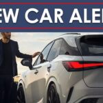 A white 2024 Lexus RX 450h+ is shown from the rear with the driver approaching.