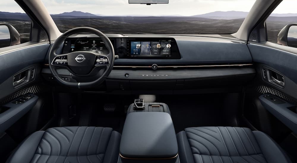 The gray and black interior and dash of a 2023 Nissan ARIYA is shown.
