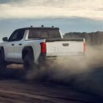 A white 2024 Toyota Tacoma TRD Pro is shown from the rear at an angle after leaving a Toyota dealer.