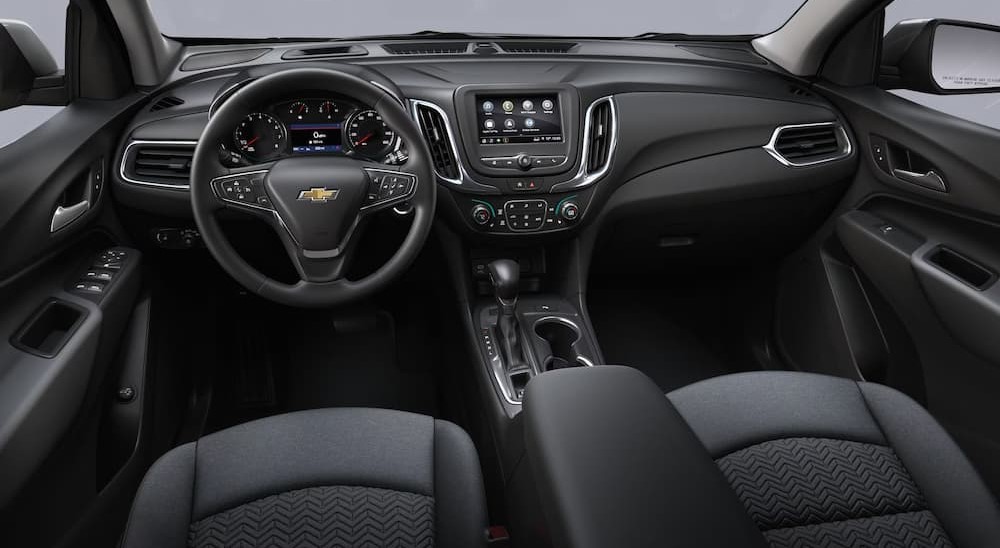 The black interior and dash of a 2023 Chevy Equinox LT is shown.