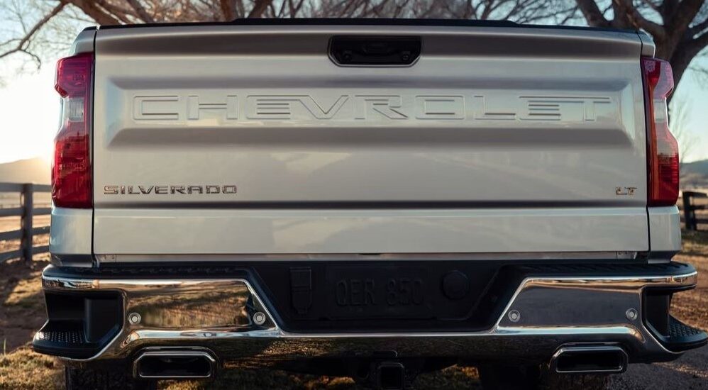 A close-up on the back of a white 2023 Chevy Silverado 1500 LT is shown.