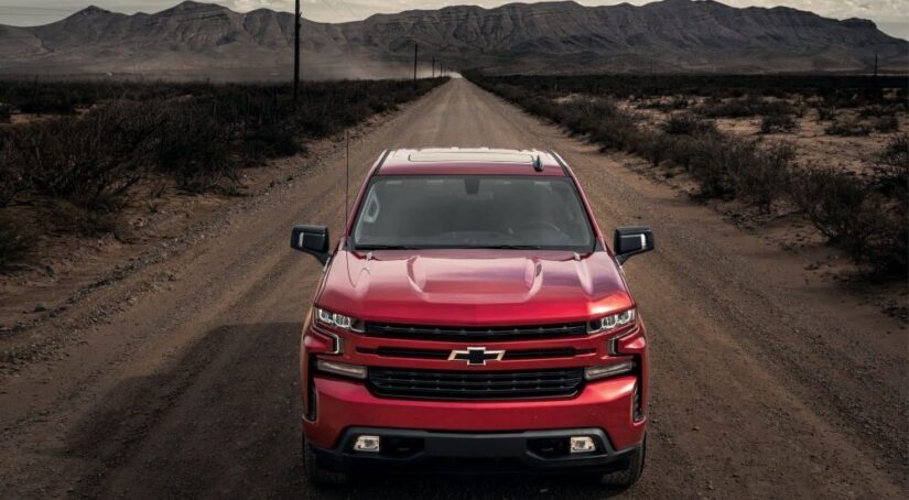 A red 2023 Chevy Silverado 1500 RST is shown driving in a desert after winning a 2023 Chevy Silverado 1500 vs 2023 Toyota Tundra competition.