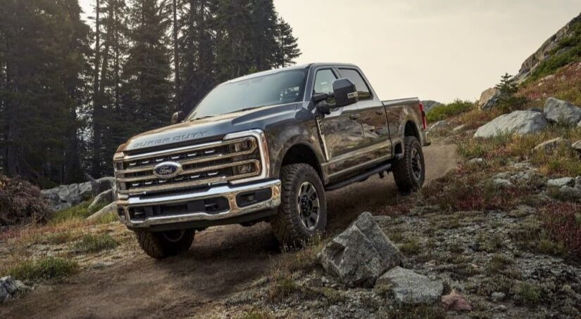 A brown 2023 Ford F-250 Tremor is shown descending a hill after winning a 2023 Ford F-250 vs 2023 Chevy Silverado 2500 HD contest.