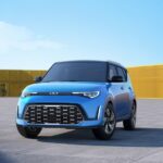 One of the more popular Kia SUVs for sale, a blue 2023 Kia Soul, is shown parked in a garage.