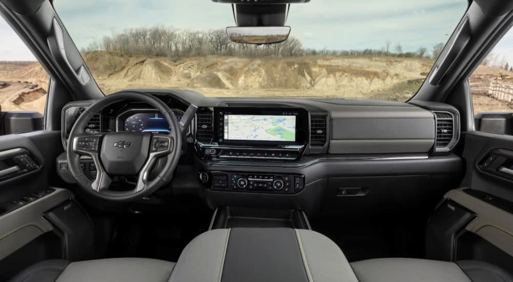 The black and gray interior and dash of a 2024 Chevy Silverado 1500 Zr2 is shown.