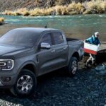 A gray 2024 Ford Ranger is shown parked off-road near water after competing in a 2024 Ford Ranger vs 2024 Toyota Tacoma comparison.