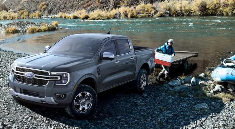 A gray 2024 Ford Ranger is shown parked off-road near water after competing in a 2024 Ford Ranger vs 2024 Toyota Tacoma comparison.