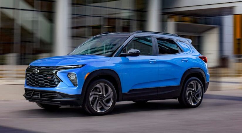 A blue 2024 Chevy Trailblazer RS is shown from the side on a city street.
