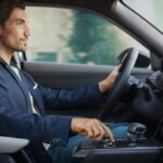 A person is shown driving a 2023 Mazda MX-30 after looking at electric vehicles for sale.