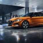 An orange 2023 Nissan Sentra is shown parked after competing in a 2023 Nissan Sentra vs 2023 Toyota Corolla comparison.