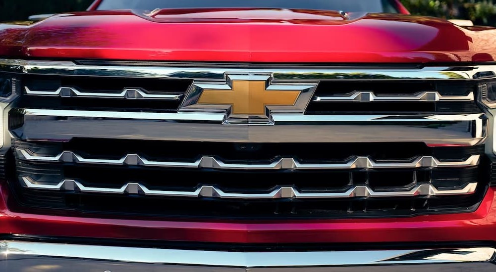 A close-up of a chrome grille on a 2023 Chevy Silverado 1500 is shown.