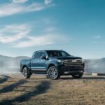 A blue 2023 Chevy Silverado 1500 LT is shown parked on a farm after visiting a Chevy dealer.