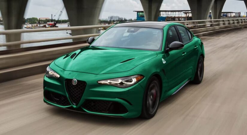 A green 2024 Alfa Romeo Giulia is shown driving.