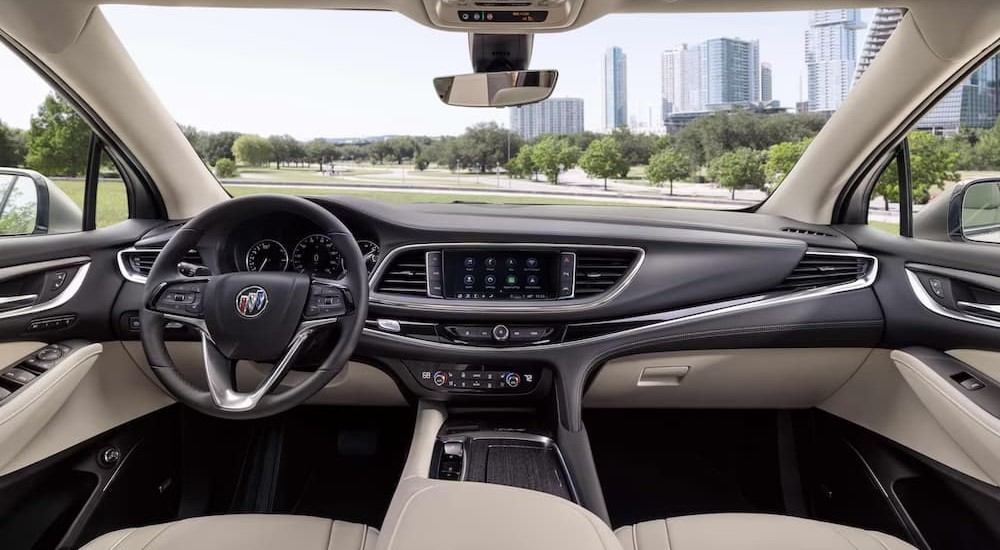 The black and white interior and dash of a 2024 Buick Enclave is shown.