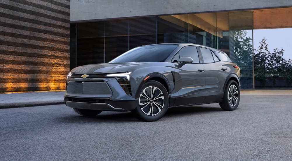 A gray 2024 Chevy Blazer EV is shown parked near a lighted building.