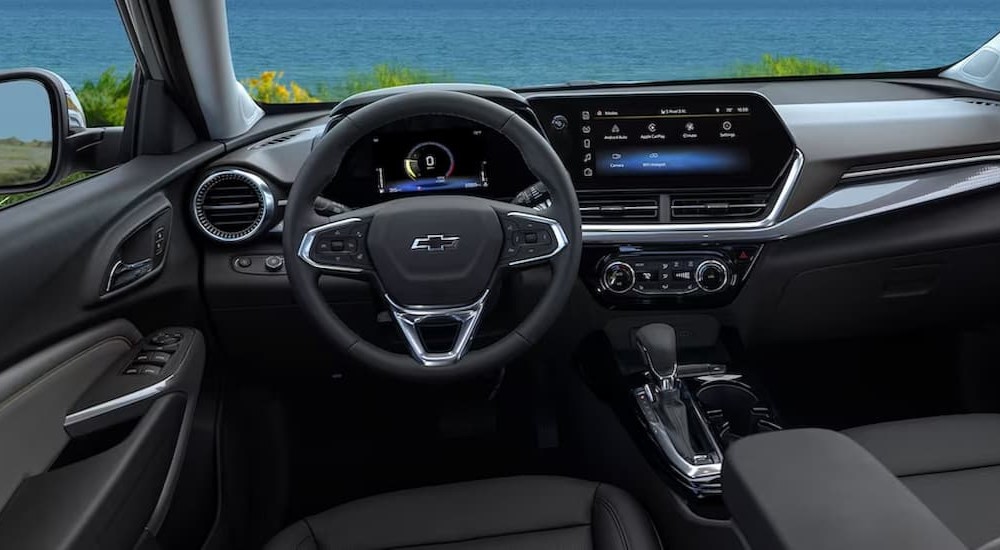 The black interior and dash of a 2024 Chevy Trax is shown.