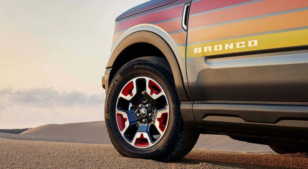 A close-up on the front wheel of a black-orange 2024 Ford Bronco Sport Free Wheeling Edition is shown.