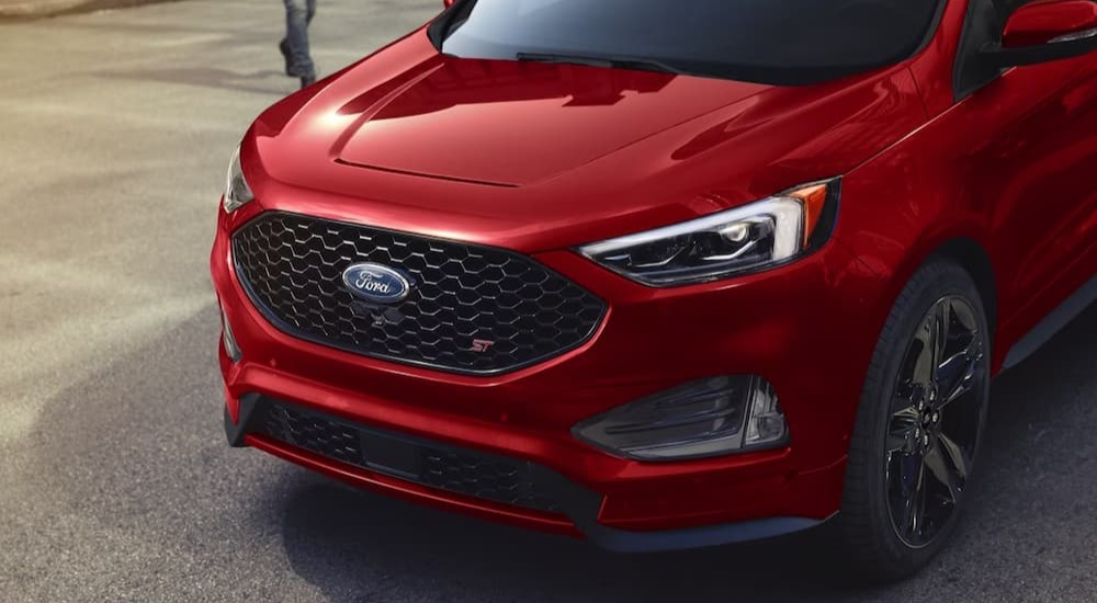 The close-up of the front of a red 2024 Ford Edge ST is shown.